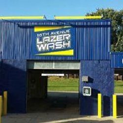 A covered wash bay at 16th Ave Lazer Wash with the 16th Avenue Lazer Wash sign